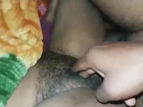 Indian wife's hairy private parts are being pleasured and penetrated by her spouse