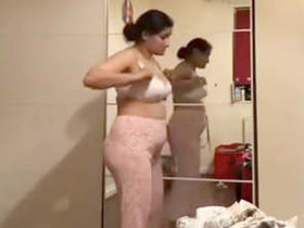 Pakistani milf strips down to a white bra and flashes her pantyless ass