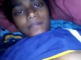 Aroused young woman displays her breasts and indulges in self-pleasure