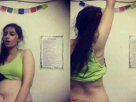 A seductive Indian beauty performs a sensual dance, showcasing her toned stomach