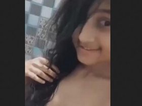 A stunning Asian beauty takes a bath while displaying her charm