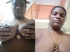 A sultry South Indian housewife flaunts her sensual curves and intimate areas in a provocative solo video.