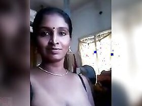 Desi with big saggy tits poses for the camera and masturbates with a toy