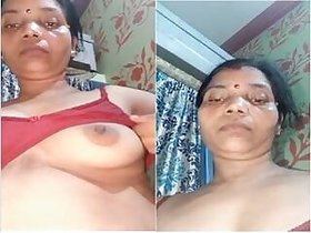 A horny Desi Bhabhi shows off her tits and pussy